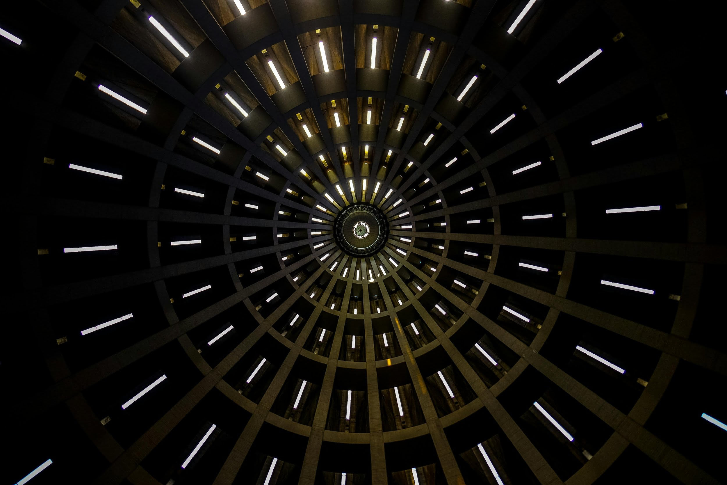 Looking up at a circular, art deco ceiling feature.